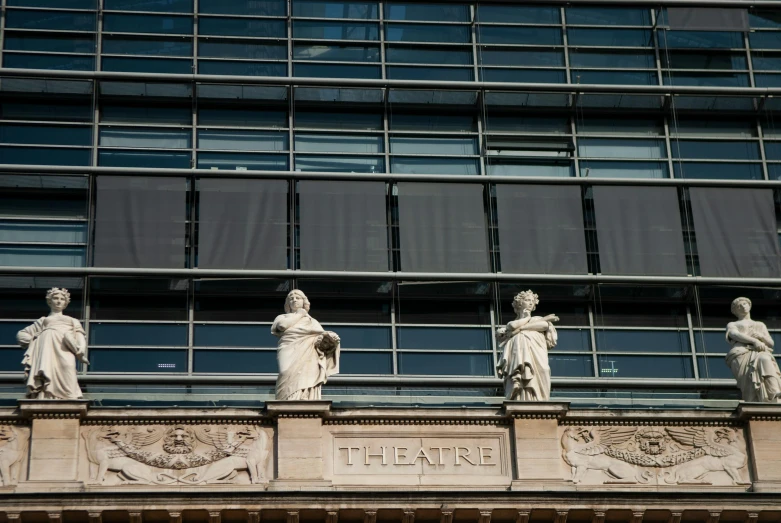 statues of goddesses on a building ledge