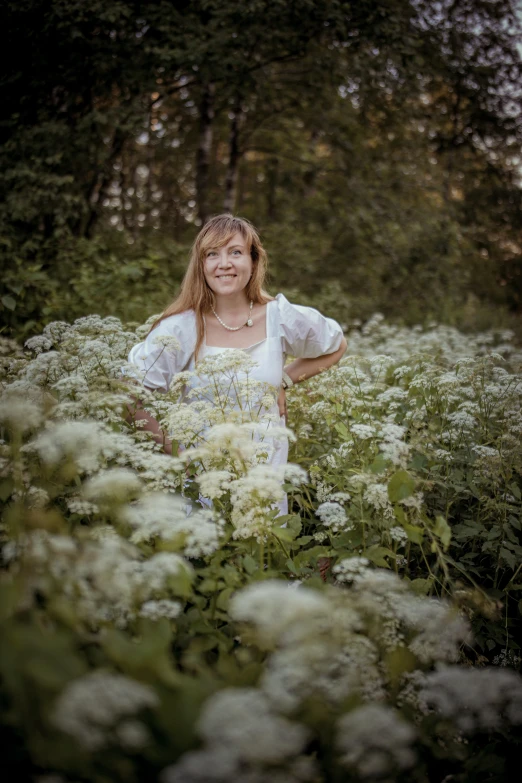 an image of a woman that is posing in flowers