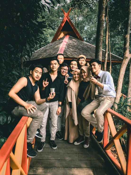 a group of friends pose for a po on the bridge