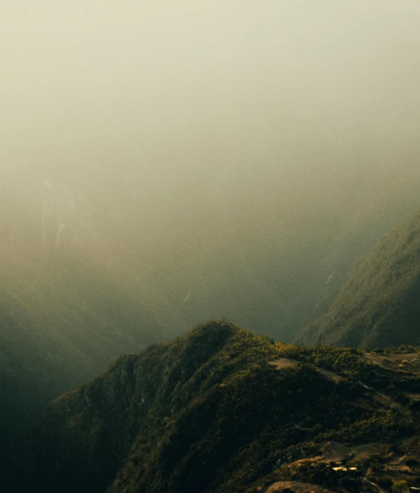 a long view of a mountain with fog