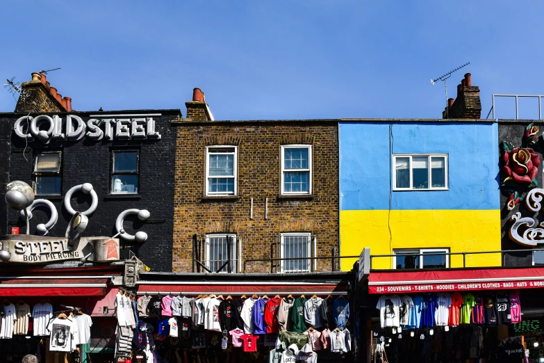 a group of buildings with clothing on display