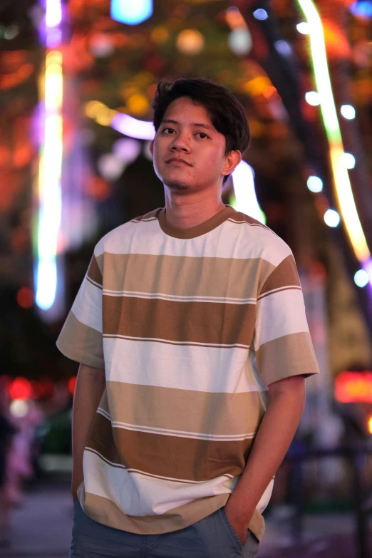 young man in striped shirt with his hands on hips