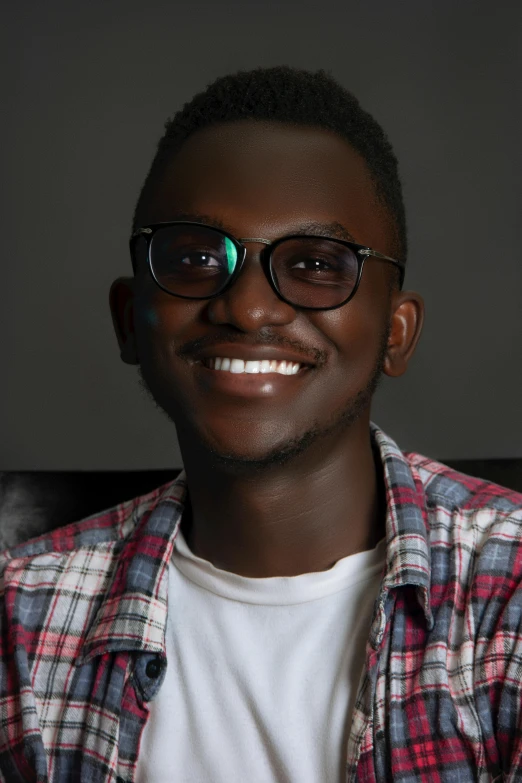a man is smiling with glasses on
