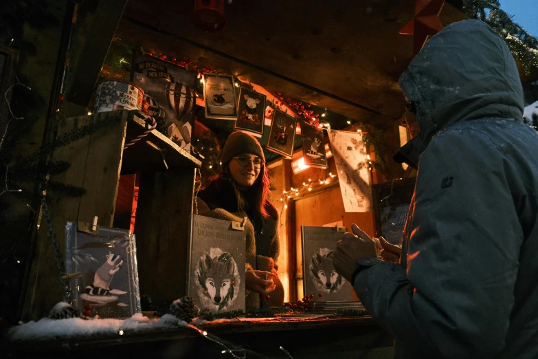 two people looking at pos on display in a dark room