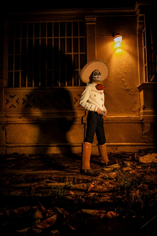 a man is wearing a cowboy hat and boots