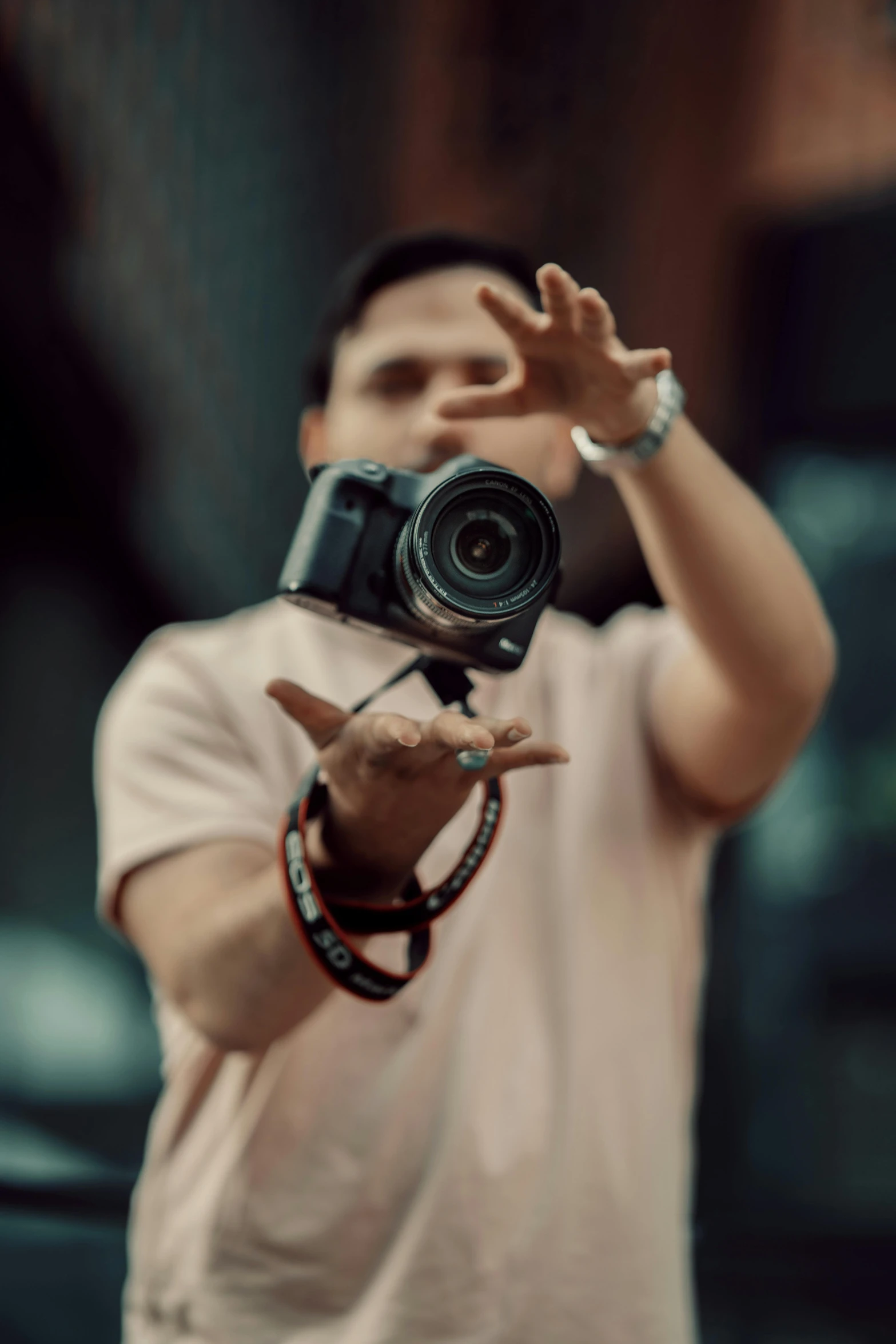 a man holding up his hand and pointing with the camera to the side