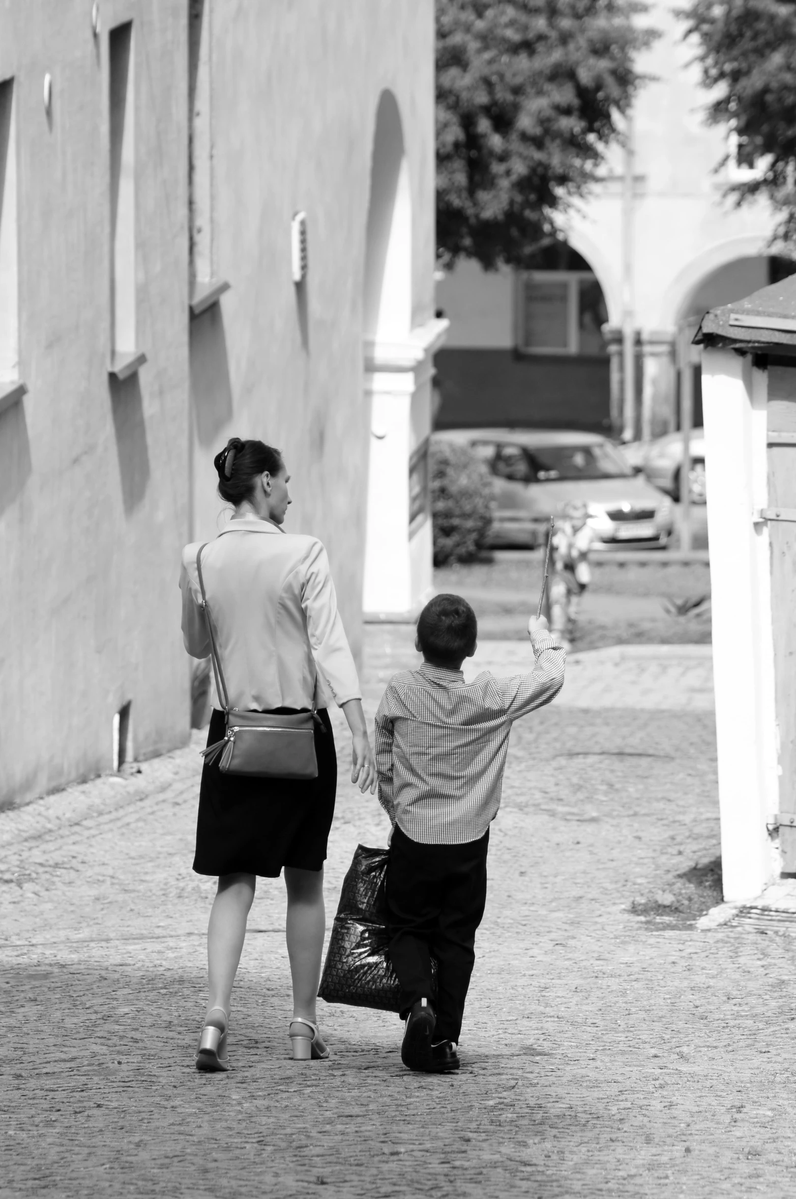 a man is walking with a bag and woman