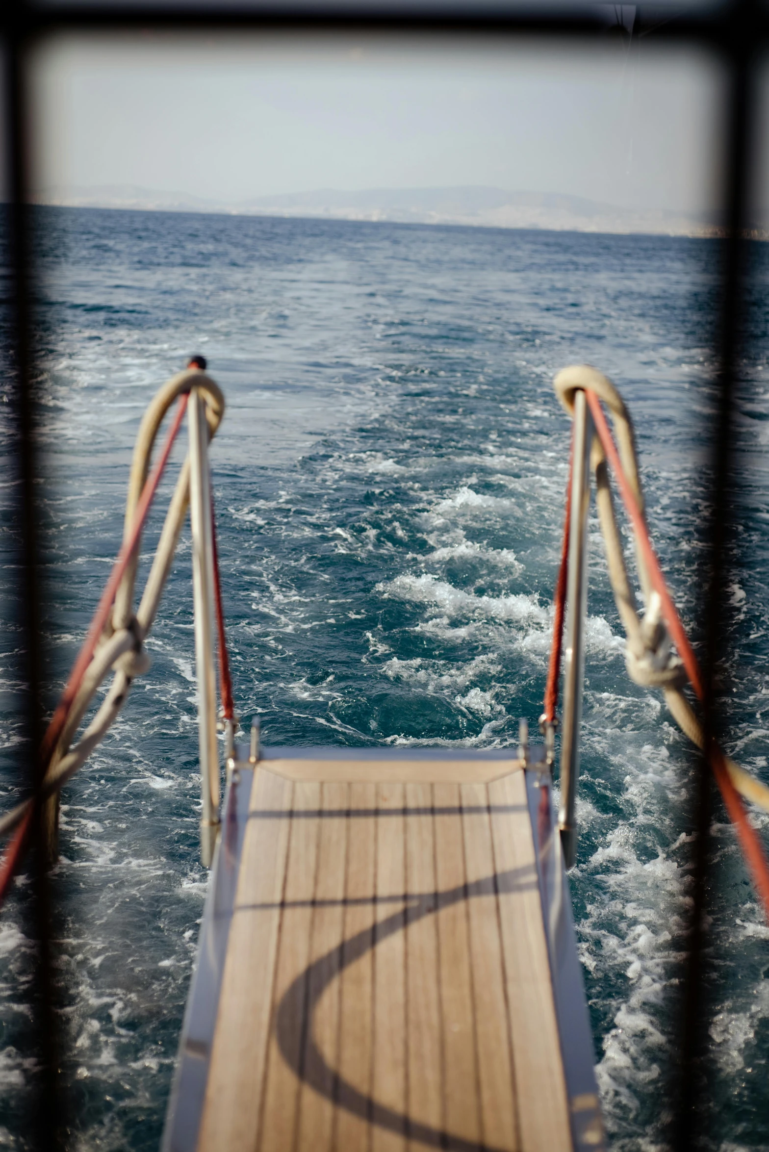 view from inside the front of a ship on the sea