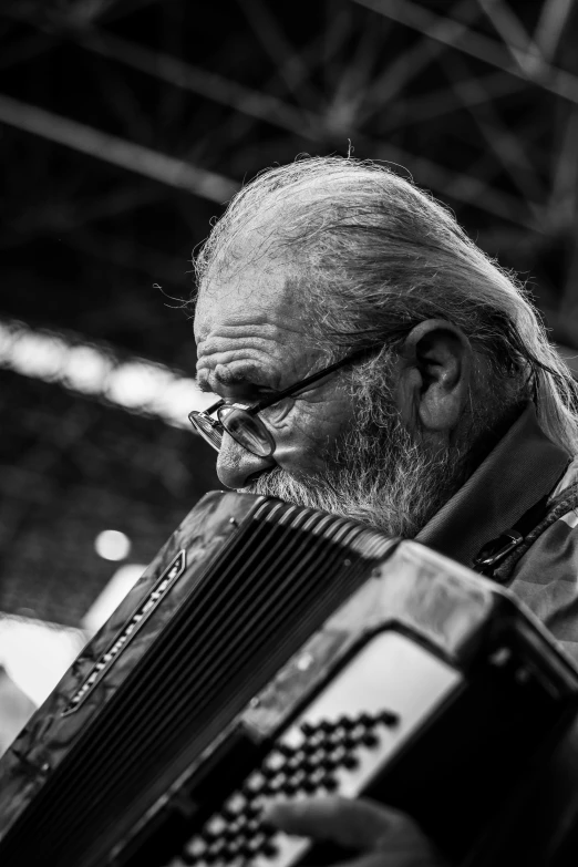 black and white po of man playing the accordion