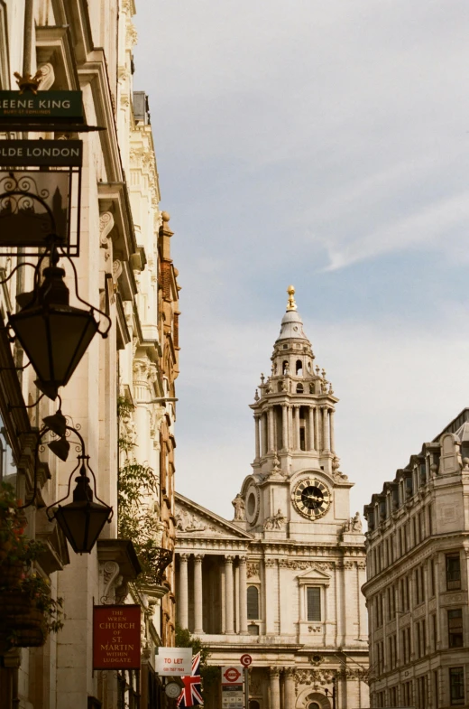 an old building with a clock and bell tower towering over the city