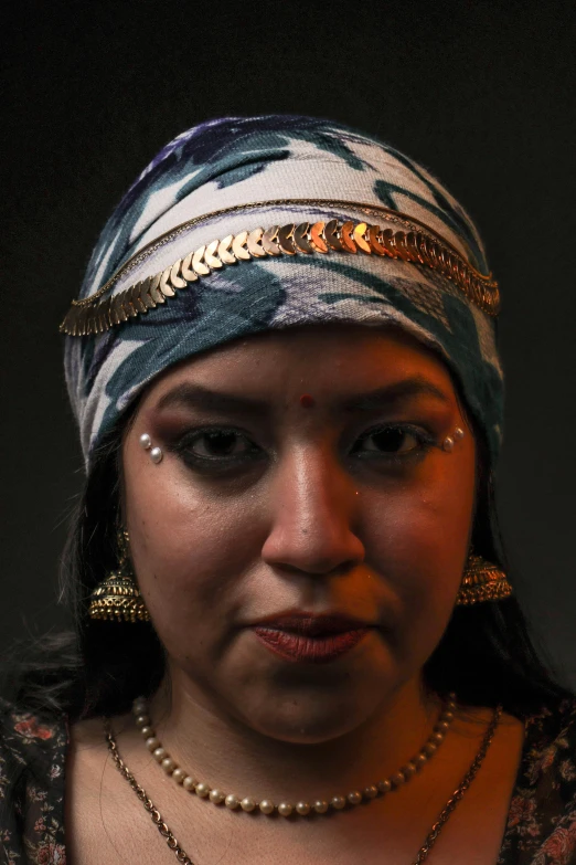an indian woman in a headscarf with jewels on her head