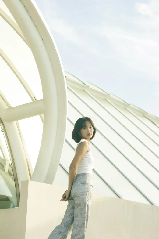 an attractive young lady in white posing for a picture