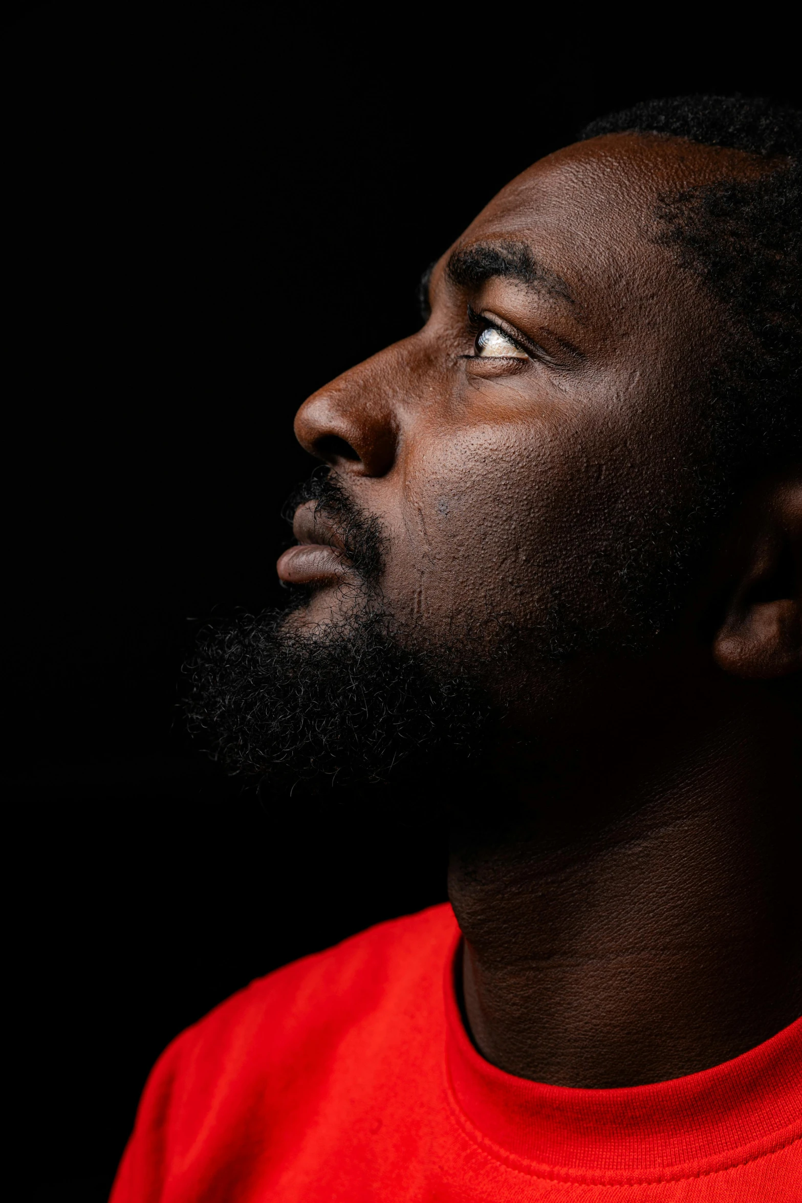 a man with a beard wearing a red shirt