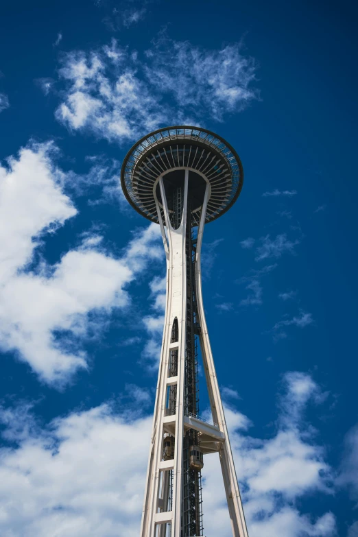 a tall white object under a cloudy blue sky