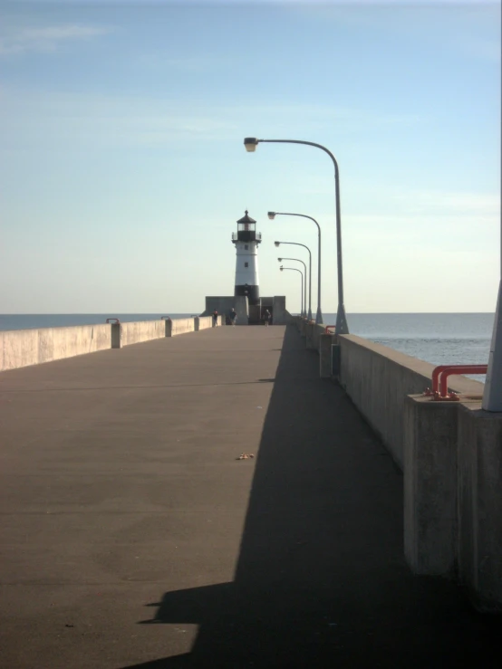 a light house on a large pier in the distance