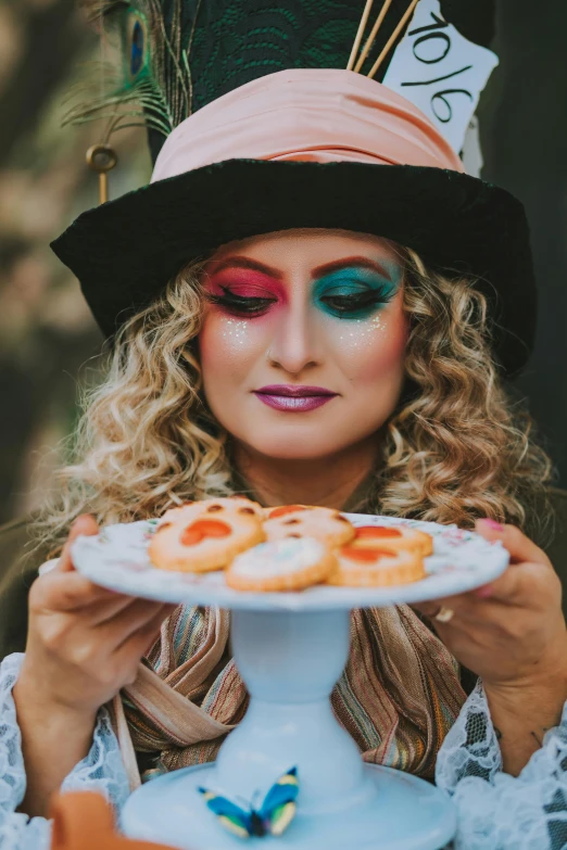 woman in a colorful mask holding a plate of food