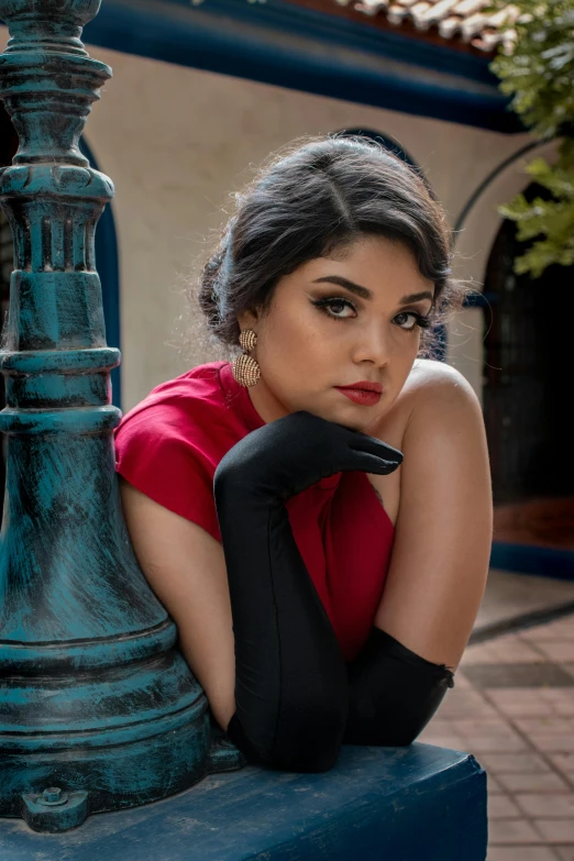 a woman in red shirt sitting on a post