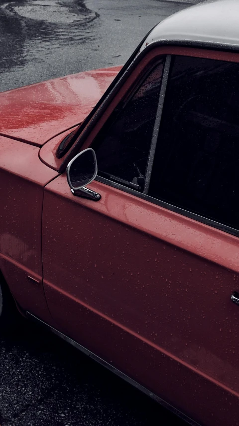 a red car parked in front of an apartment building