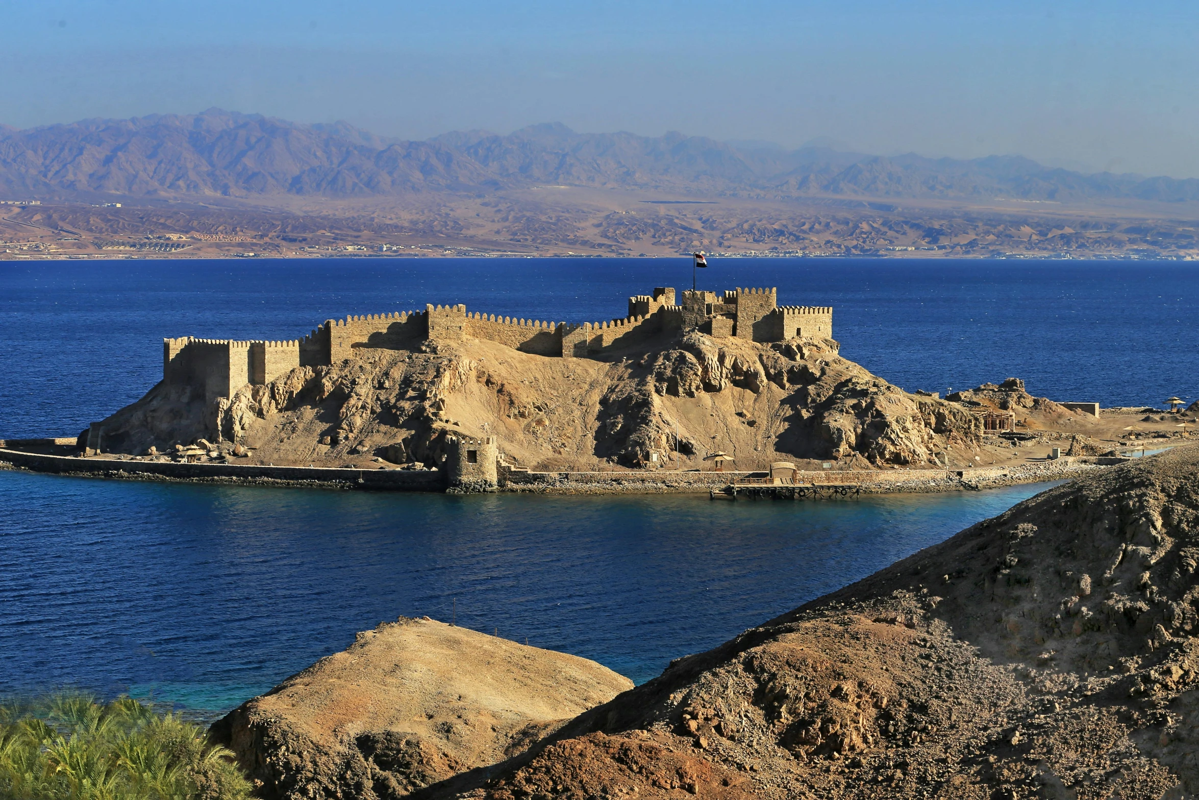 a castle on a small island in the middle of the water