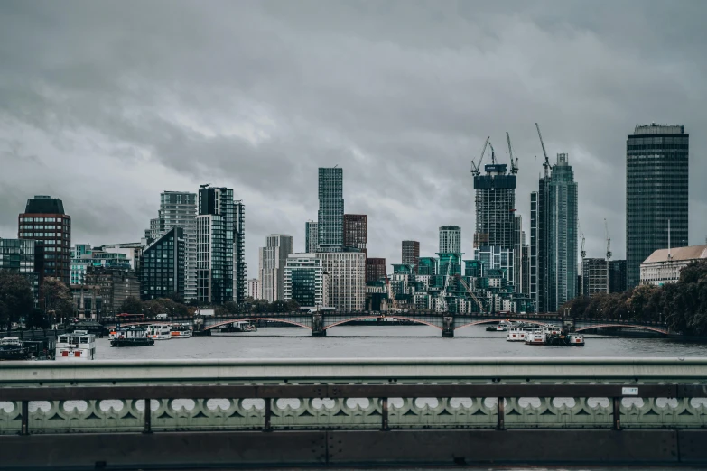 the view of london on a cloudy day from across the thames