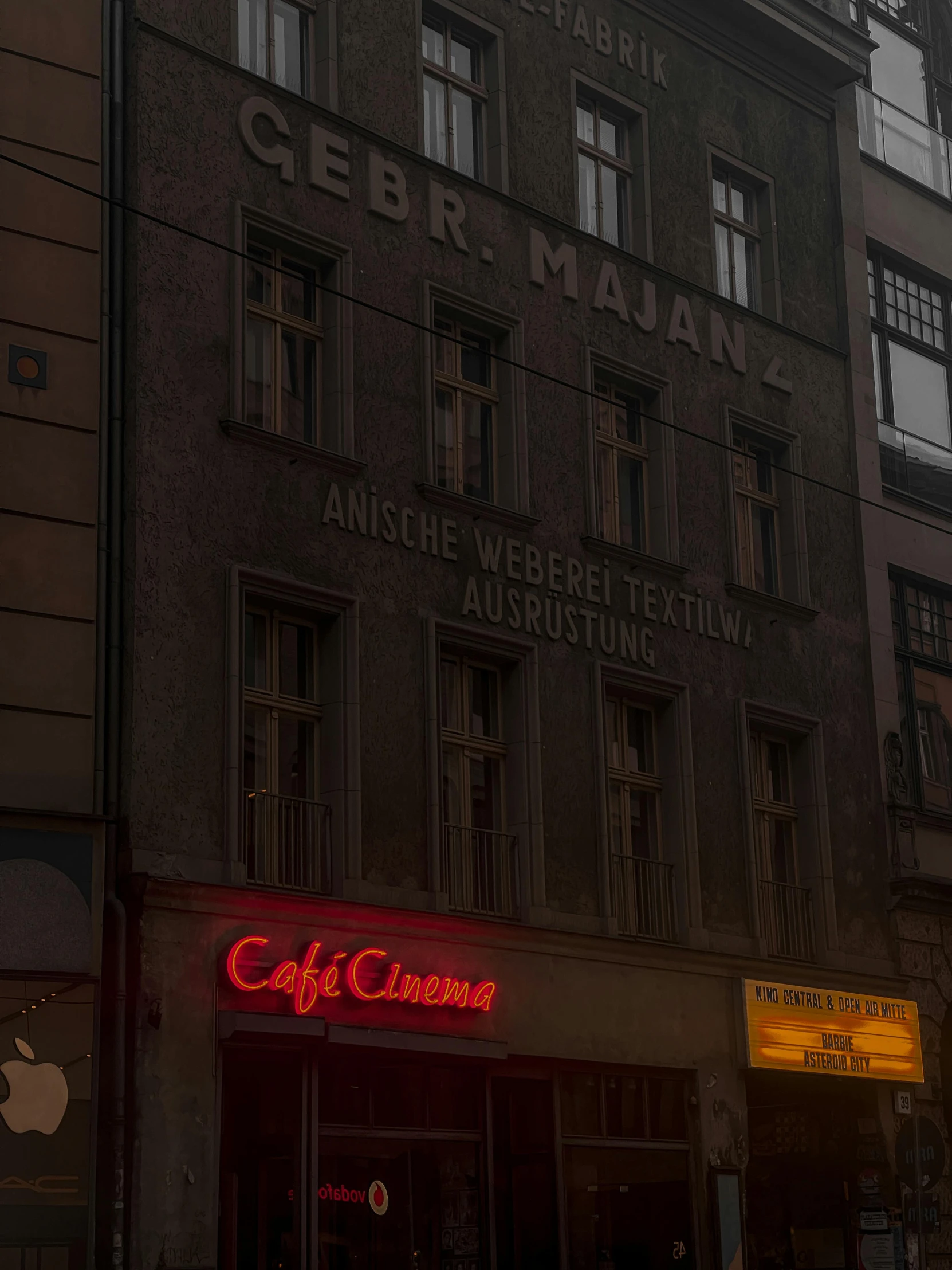 a store with some red neon lights in front of it