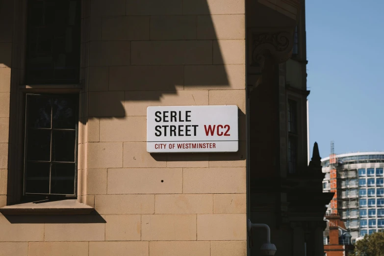 a sign on the side of a building telling that people will serve street w2