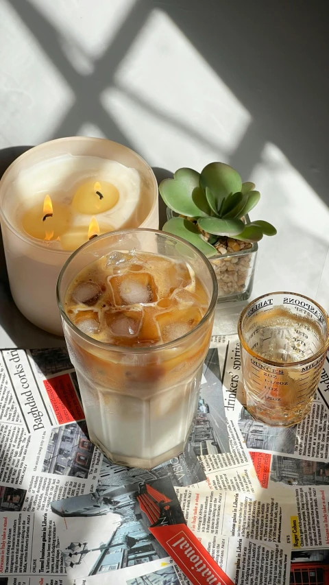 a couple of drinks are sitting on top of newspaper