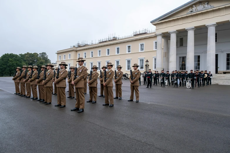 a group of people are dressed in uniform and standing in front of a building