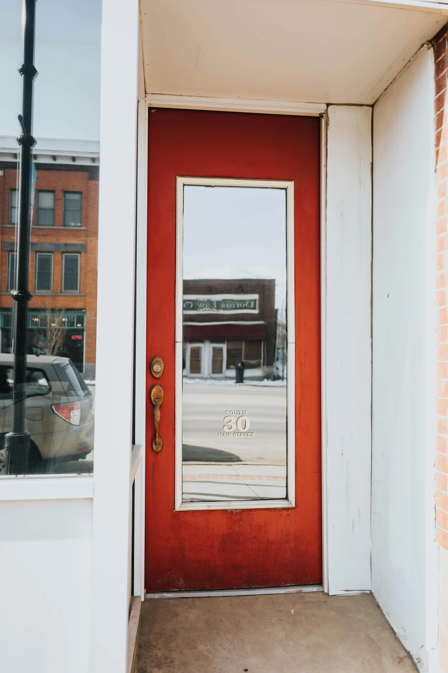 the reflection of buildings on a door outside