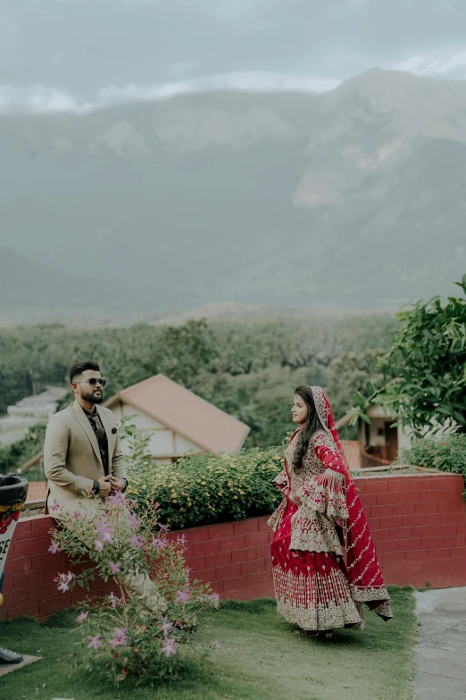 the bride and groom stand in front of a scenic view