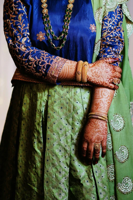 the bride is wearing an elaborate bridal outfit