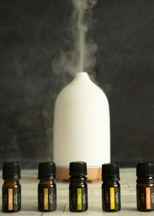 bottles of oils on the table, steam rising from one bottle