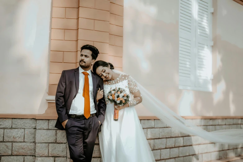 the couple is posing together with their veil hanging over them