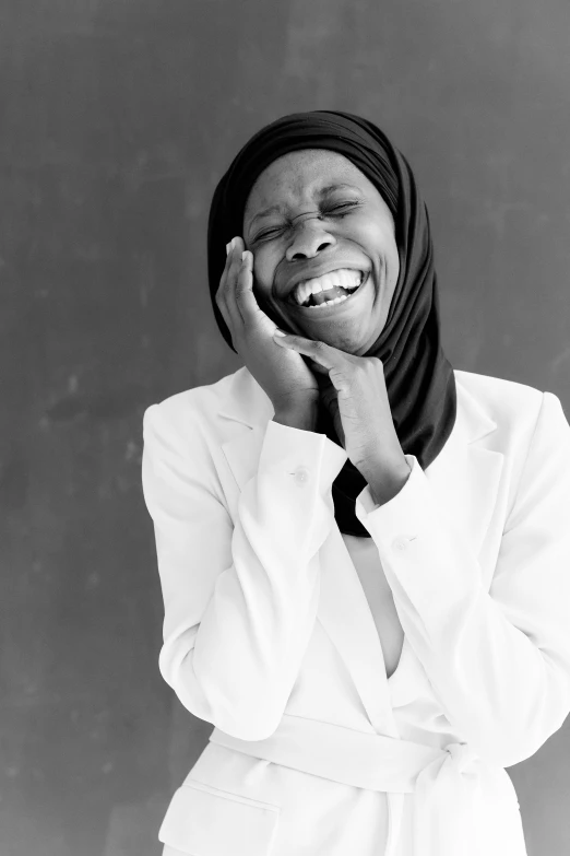 an older woman with a hat smiles as she leans in to a pose