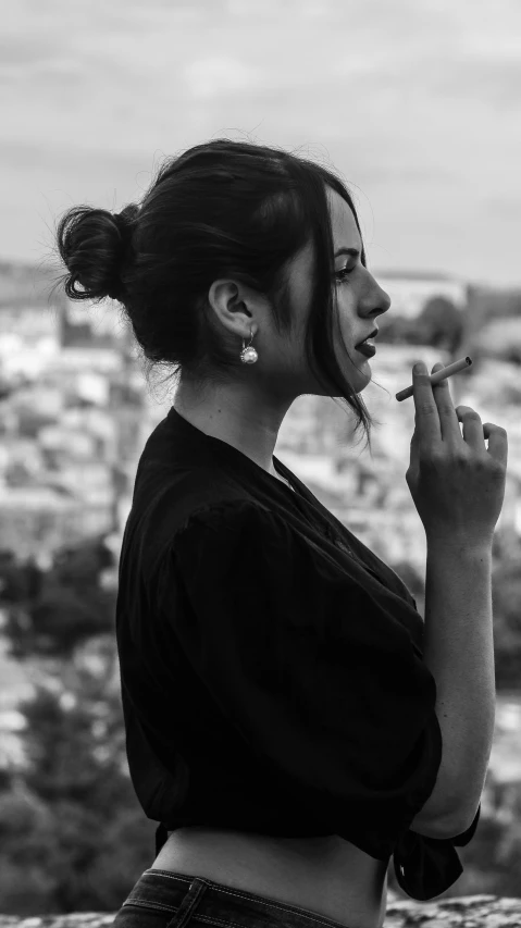 black and white pograph of a young woman smoking