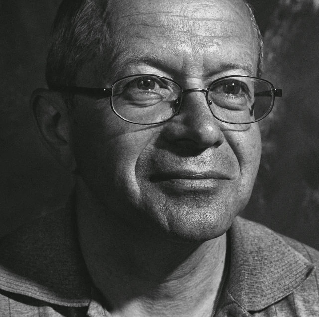 a black and white pograph of a man wearing glasses