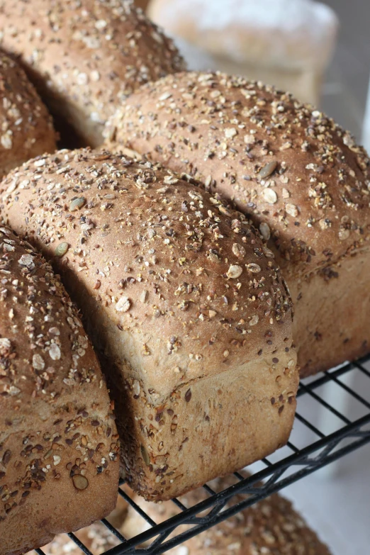 a close up of many different types of bread on a rack