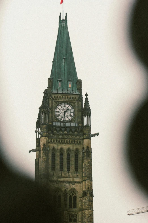 there is a tall clock tower with a flag on top