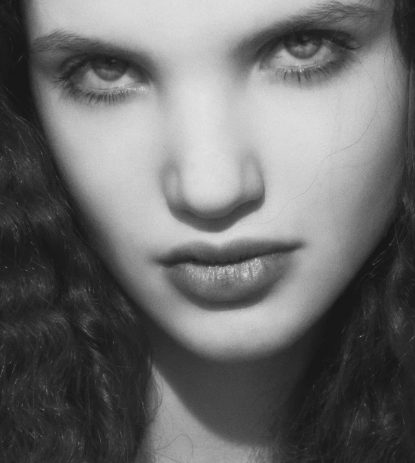 a close up of a girl with long hair and eyes