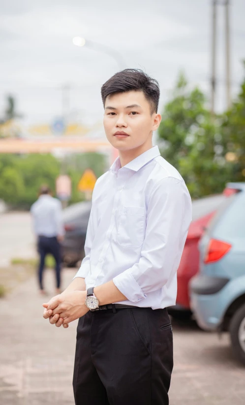 a young man in white shirt and black pants