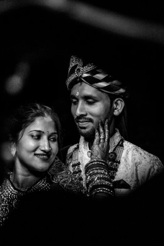 a man and woman standing in the dark