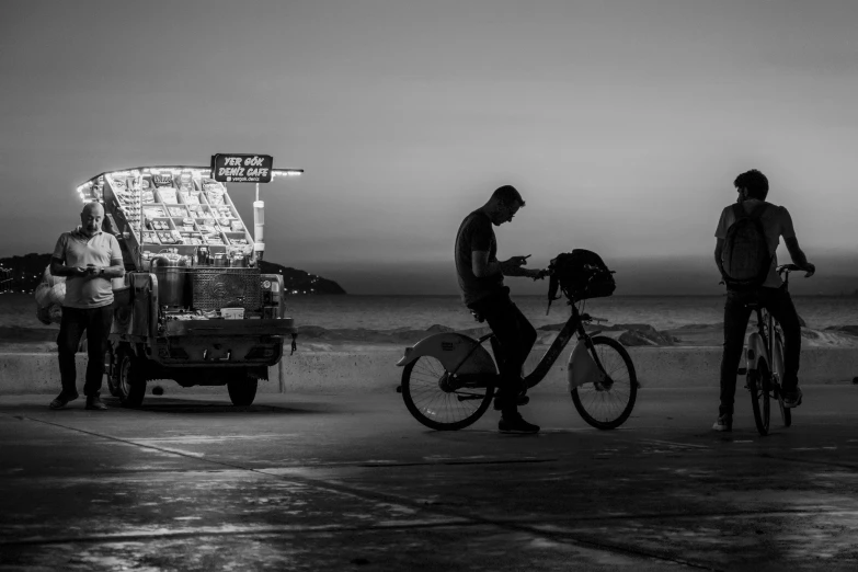 some guys with their bikes by some vehicles