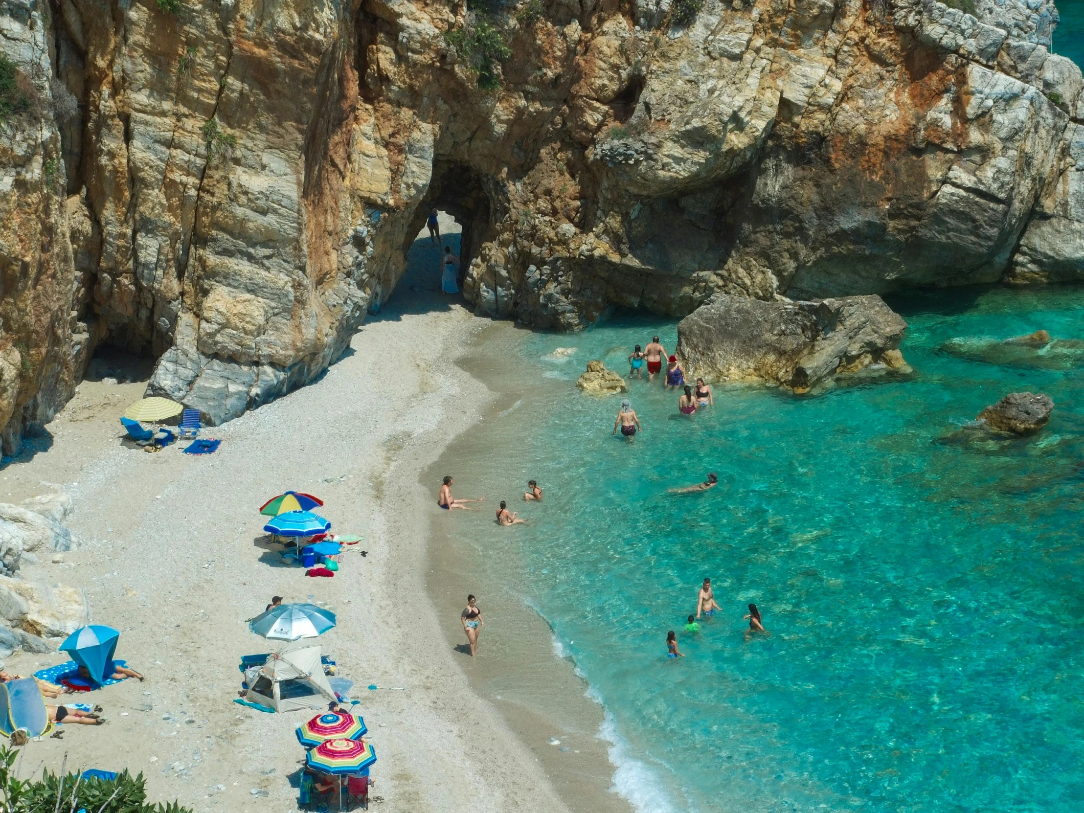 people enjoying the beach and the cliff sides