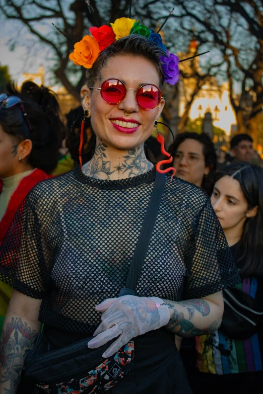 a woman wearing glasses and tattoos and a head dress