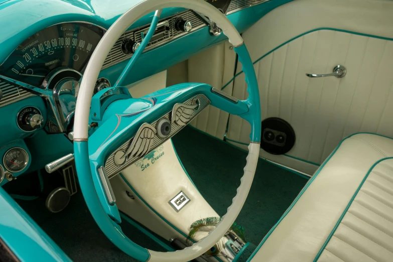 a blue car with a leather steering wheel and center console