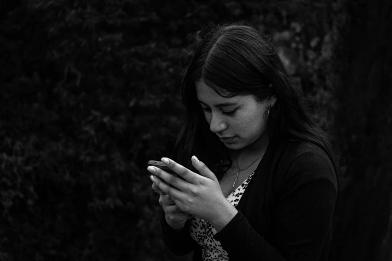 a girl is holding a cellphone in her hands