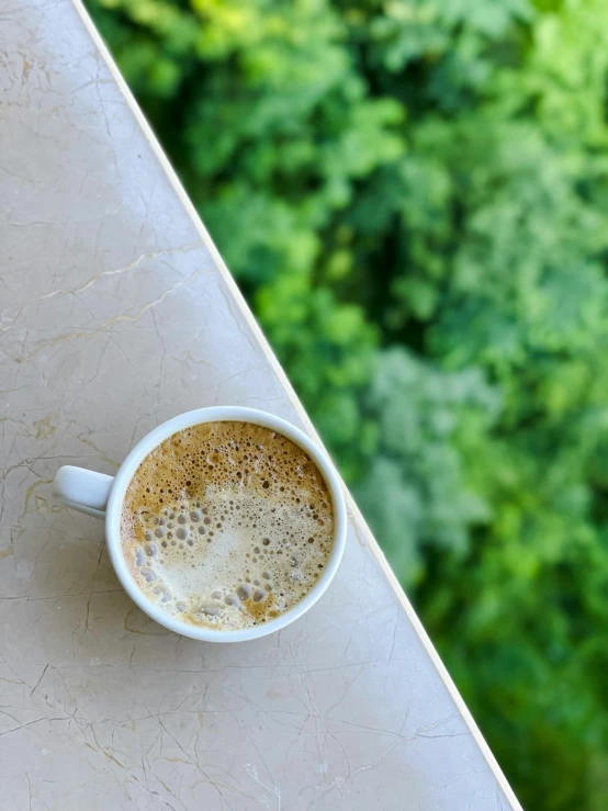 there is a cup of coffee sitting on the table