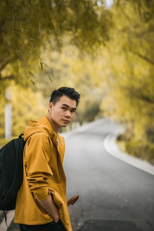 a man with a backpack standing on the side of the road