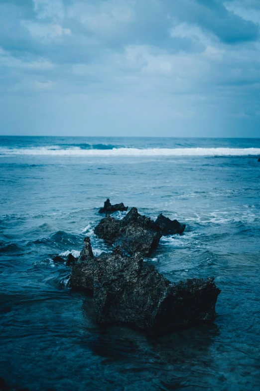 three rocks in the middle of the ocean