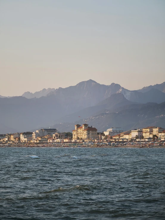 some mountains are in the distance near a body of water